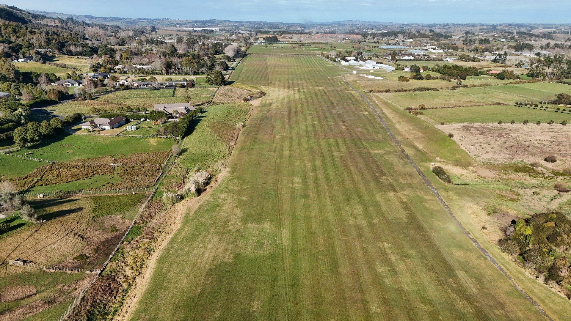 Wide aerial view of Drury Gliding Club runway and surrounding airfield after mowing